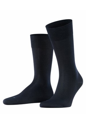 Schwarze Socken aus einem glatten, elastischen Material. Sie verfügen über einen gerippten Bund und eine nahtlose Zehenpartie, die einen engen Sitz und Komfort bieten.