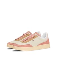 Sneakers with a light beige fabric upper, pink suede accents, cream rubber sole, and flat laces. Features a small logo on the side.