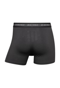 Boxers ajustados negros con una textura suave, con una cinturilla gris estampada con "JBS UNDERWEAR" y un sutil patrón geométrico.