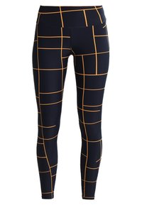 Leggings blu navy con un motivo a griglia arancione. Vita alta, materiale elasticizzato, design aderente, adatti per l'attività fisica.