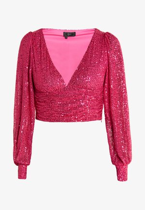 Rožinė blizgi laisvalaikio palaidinė su giliais V formos iškirpte ir ilgomis pūstomis rankovėmis. Audinys blizga, o jo kūnas dekoruotas susiraukšlėjimais.