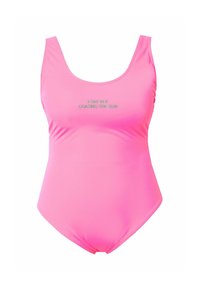 Vaatekappale vaaleanpunaisista uimapuvuista, joissa on syvä kaula-aukko ja leveät hihnat. Käsittelee tekstiä "IKUISEN AURINGON PERÄN" vihreällä värillä. Sujuva, joustava kangas, jossa on minimalistinen muotoilu.