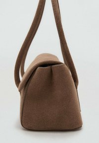 Bolso de mano de ante marrón con base estructurada, cierre de solapa suave y curva, y dos largas correas para el hombro. La superficie parece texturizada y suave.