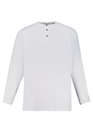 Camicia bianca a maniche lunghe con scollatura rotonda, patta con tre bottoni e dettagli del logo discreti. Realizzata in tessuto leggero e strutturato.