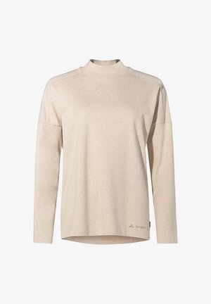 Beige long-sleeve top with a mock neck, made from soft fabric. Features dropped shoulders and a rounded hem. Logo printed on the lower left side.