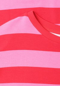 Red and pink horizontal striped knit shirt with a ribbed crew neckline, showing fabric texture and stitching details.