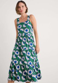 Rochie florală cu un model albastru și verde, decorat�ă cu margarete albe. Decolteu pătrat, design fără mâneci și tiv în straturi, cu o croială lejeră.