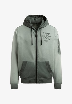 Gray-green zip-up hoodie with front pockets, drawstrings, and "Camp David No 01 North to South" text and camping graphics on the chest.