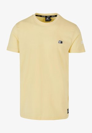 Sárga, rövid ujjú, pamut póló. Kis fekete logó található a mellen, és márkás részlet az ujjon. Kerek nyakú fazon.