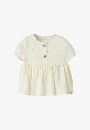 Blouse bébé à manches courtes couleur crème avec broderie florale en ajouré, col rond, deux boutons en bois à l'avant et taille froncée.