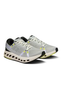 Light gray running shoes with mesh upper, contrasting dark heel, white laces, and yellow accents. Featuring a cushioned sole with ventilation holes.