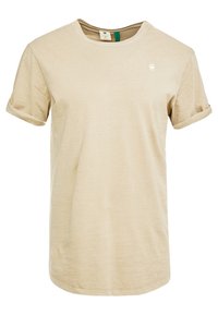 Beige tričko s krátkým rukávem vyrobené z jemné látky, s kulatým výstřihem, svěšenými rukávy a malým logem na hrudi.