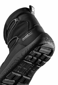 Czarny wodoodporny but z textured górą, elastyczną konstrukcją i wytrzymałą gumową podeszwą z wyraźnym wzorem bieżnika.