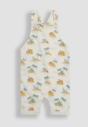 Käyntehkä valkoinen kangashaalari, jossa on dinosaurusten ja palmupuiden kuviota, säädettävät olkaimet ja kaksi nappisuljinta edessä.