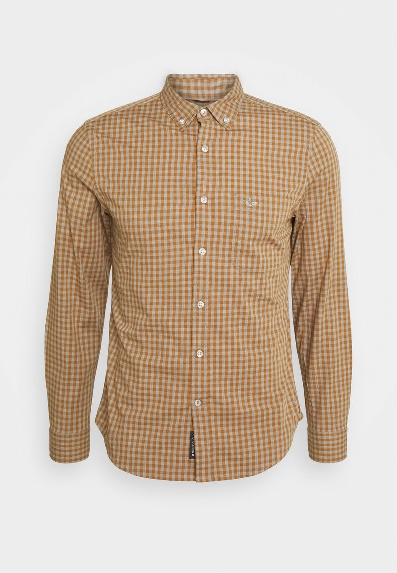 Chemise à manches longues boutonnée avec un motif à carreaux vichy marron et beige et un petit logo brodé sur la poche poitrine gauche.