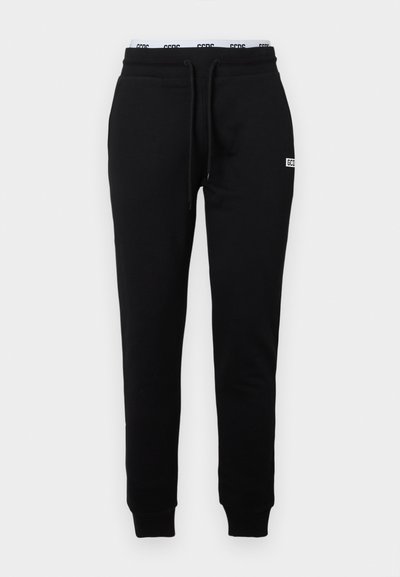 Black sweatpants made of smooth fabric, featuring a drawstring waist, tapered legs, and a small logo on the front left side.