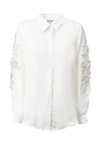 Camicia bianca con bottoni, maniche lunghe, caratterizzata da ricami floreali argentati e dettagli di perline sulle maniche. Collo classico e vestibilità slanciata.