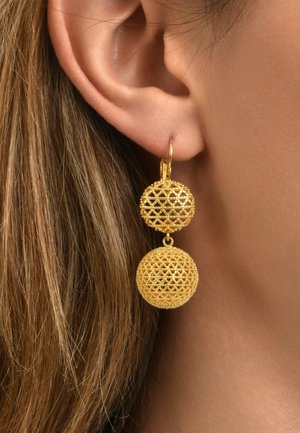 Boucles d'oreilles en fil d'or avec deux formes sphériques : l'une texturée et en nid d'abeille, l'autre lisse et ronde, suspendue à un anneau.