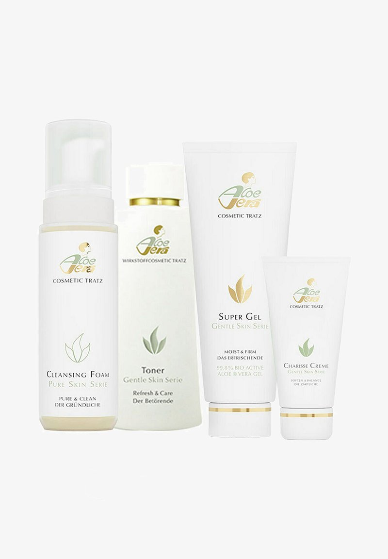 Fünf kosmetische Produkte in weißen und hellgrünen Tuben und Flaschen zeigen grüne Blattgrafiken. Die Etiketten geben Reinigungsschaum, Toner, Supergel und Creme an.