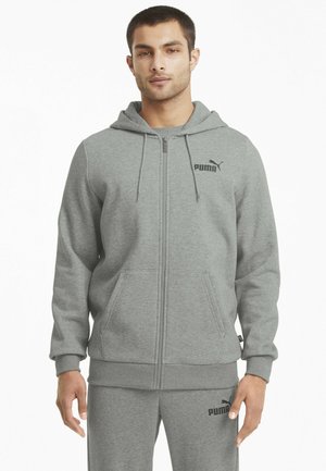 Szara bluza z kapturem na zamek, wykonana z miękkiego materiału, z kieszenią typu kangur, kapturem i elastycznymi mankietami. Posiada czarne logo Puma na piersi.