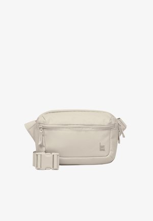 Beige crossbody bag made of fabric, featuring a front zipper pocket, adjustable strap, rounded corners, and a logo label.