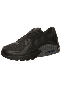 Black Nike Air Max sneakers featuring a combination of mesh and leather materials, textured accents, and a visible air cushioning unit.