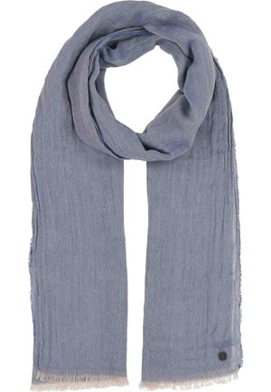 Light blue textured scarf with fringed edges, loosely folded at the top, and a small round black logo at the bottom right corner.