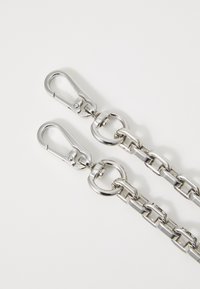 Silver metal chain with two hook clasps. Features interlocking links and circular rings, polished finish, sturdy design.