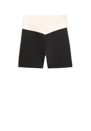 Shorts color block noir et crème avec une taille haute. Présente une texture lisse et une coupe géométrique pour un design moderne.