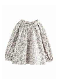 Ljusbeige långärmad topp med svart blommönster. Har elastisk halsringning och puffärmar som skapar en samlad effekt.