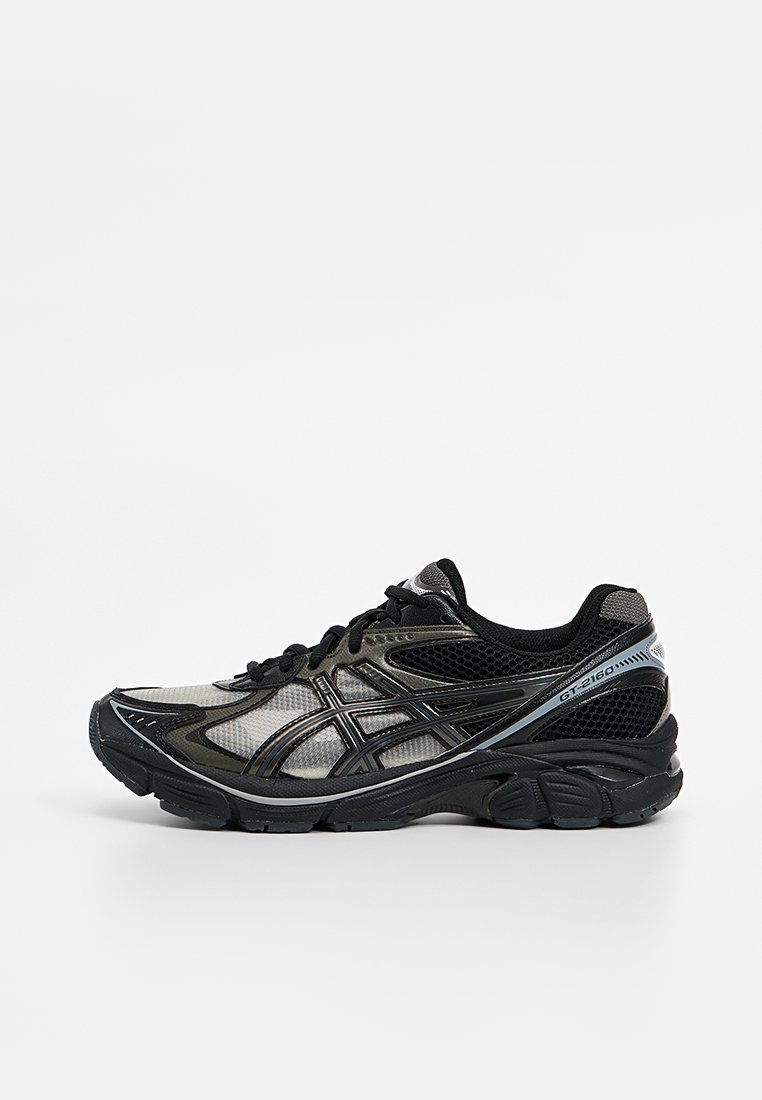 Chaussure de course noire et grise avec une tige en mesh, une semelle rembourrée et un design épuré présentant des accents argentés et un logo bien en vue.