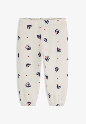 Pantalon blanc pour tout-petit avec motifs de voilier bleu marine et étoile rouge, ceinture élastique et bas de jambes resserrés aux chevilles.