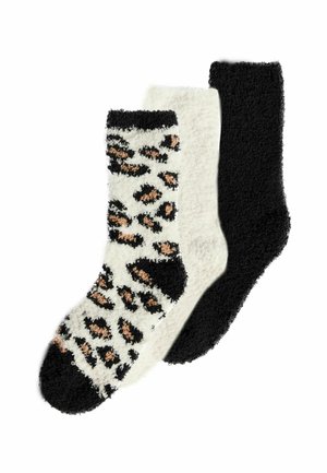 Drei Paar samtweicher Socken: eines mit einem schwarz-cremefarbenen Leopardenmuster, eines in einfarbigem Creme und eines in einfarbigem Schwarz. Weicher, strukturierter Stoff.