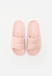 Pink slide sandals with a textured footbed and padded upper, featuring a grid pattern on the straps. Made of soft, durable material.