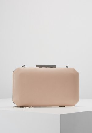 Pochette beige rectangulaire aux bords arrondis, fermoir argenté et chaîne argentée, reposant sur une surface blanche.