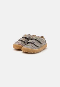 Gray suede shoes with two Velcro straps, featuring colorful dinosaur patterns and a rubber sole with a textured grip.