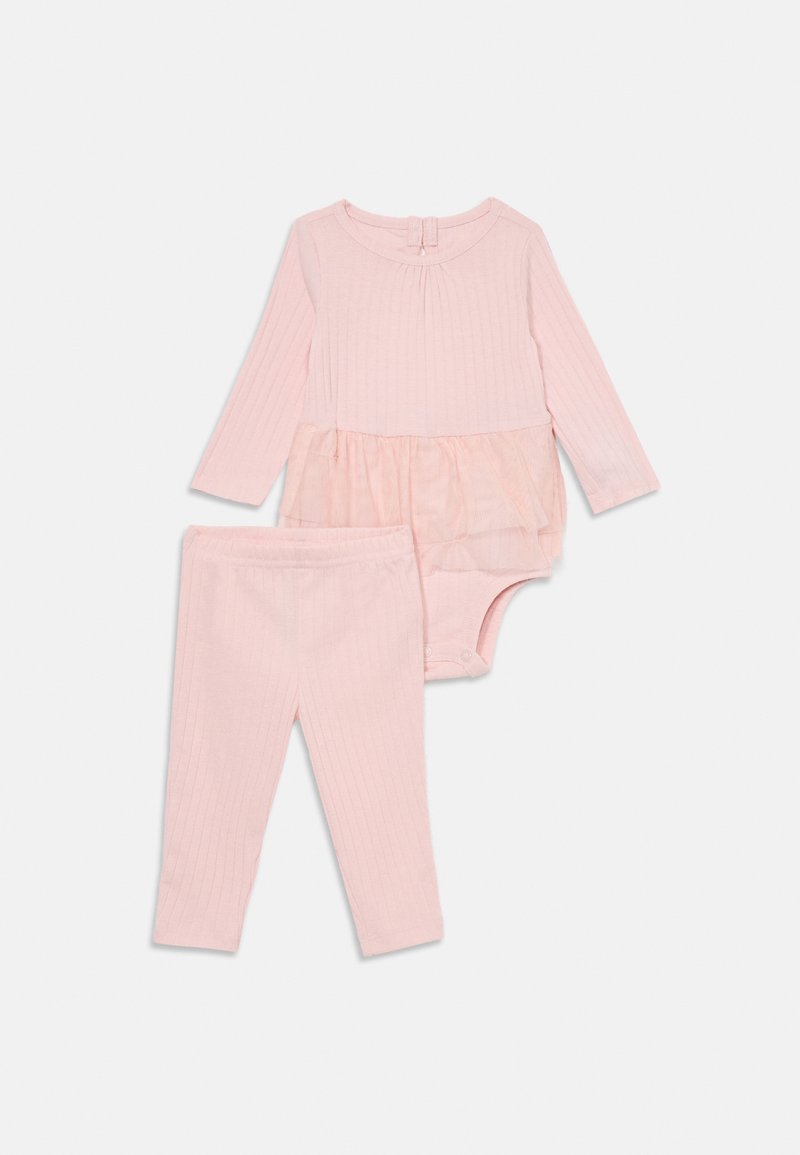 Soft pink ribbed baby outfit with long-sleeve bodysuit featuring tulle skirt overlay and matching ribbed leggings on white background.