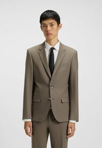 Brown suit jacket with matching trousers, made of smooth fabric. Features two buttons, notch lapels, and a chest pocket. Paired with a white shirt and black tie.