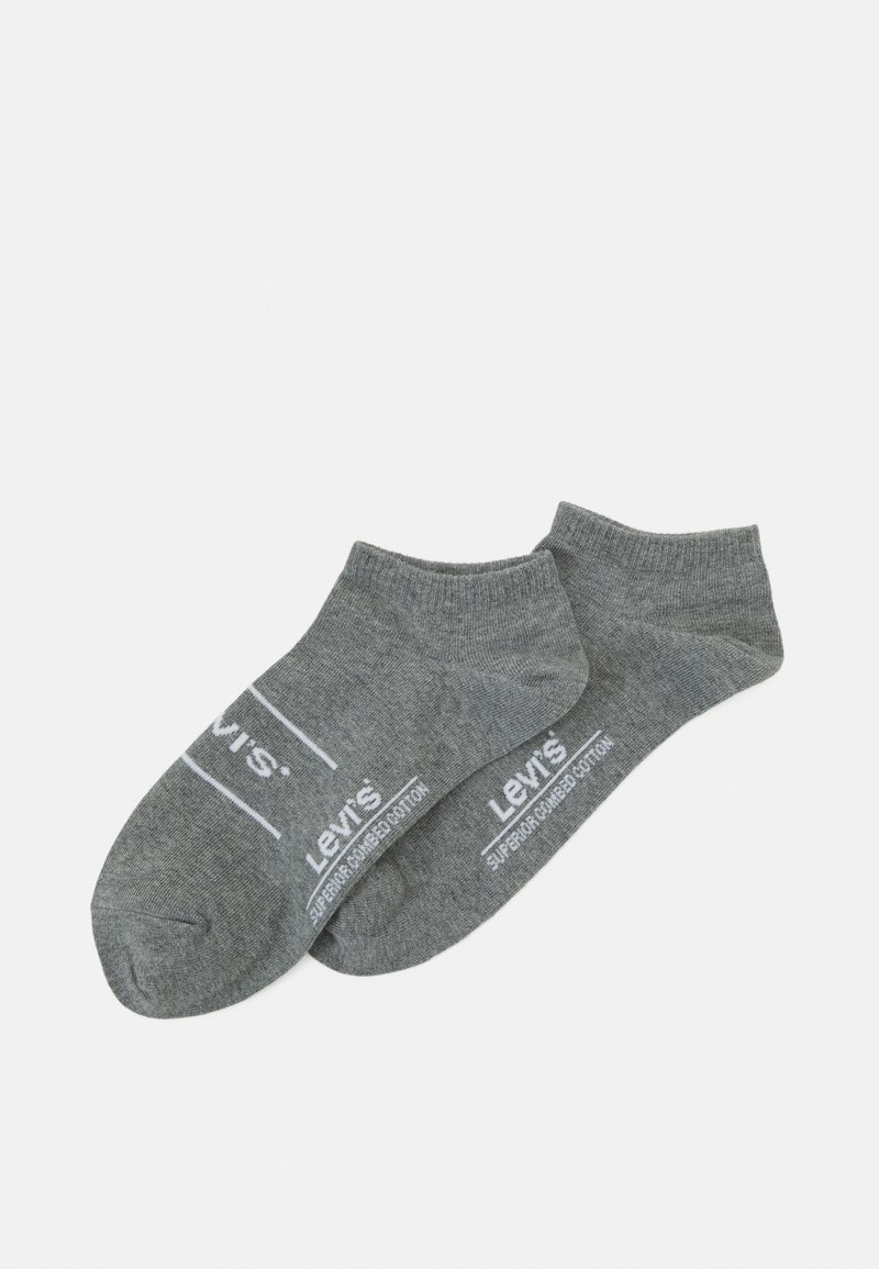 Calzini alla caviglia grigi in cotone, con un design semplice. Branding e testo bianchi ben visibili sul lato con accenti a contrasto.
