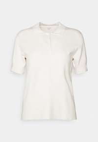 Krémový pletený polo tričko s krátkým rukávem, třemi knoflíky a měkkým límcem, umístěné na bílém pozadí.