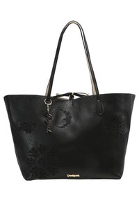 Mustat nahka-tote-laukku kohokuvioiduilla kukkakuosisilla, kaksoiskahvoilla ja kultaisilla yksityiskohdilla, jossa on nyörikiinnitys.