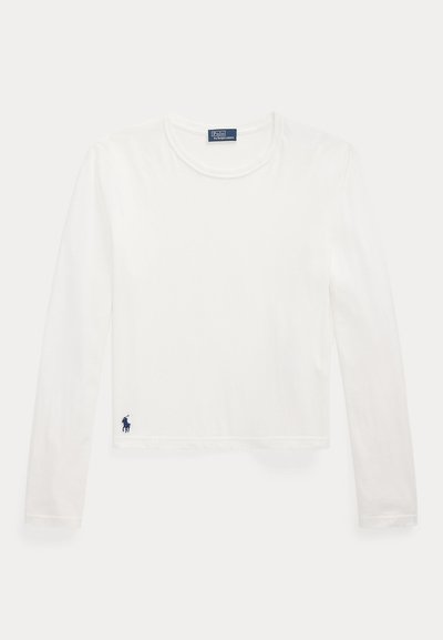 Valge pika varrukaga T-särk, mis on valmistatud pehmest puuvillast. Omab ringkaelust ja väikest sinist logo alumises vasakus servas. Sirge, lühenenud lõige.