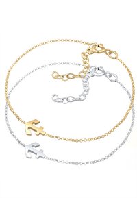 Armbandet är i guld- och silverfärgat lager, med ankarberlocker; har delikata länkar, polerad yta och karbinlås.