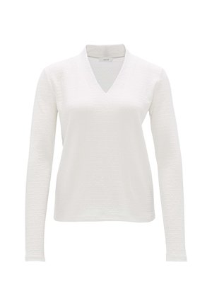 T-shirt blanc à manches longues et décolleté en V avec un tissu texturé. Design simple, matériau léger et légèrement extensible avec une coupe décontractée.