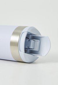 Light blue travel mug cap with open flip-top lid and silver band near the top on a white surface.