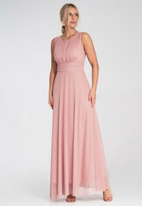 Langes, tailliertes pinkes Kleid mit rundem Ausschnitt und gefälteltem Oberteil. Der schwingende Rock reicht bis zum Boden und hat einen mehrlagigen Tüllsaum.