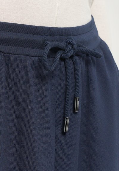 Hose mit Kordelzug in Marineblau, aus einem strukturierten Stoff, mit einem weichen elastischen Bund und dekorativen Metallenden am Kordelzug.