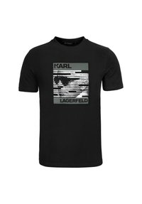 Musta puuvillainen t-paita, jossa on valko-harmaa graafinen painatus. Designissa on tekstit "KARL" ja "LAGERFELD" pystysuorien viivojen kanssa.