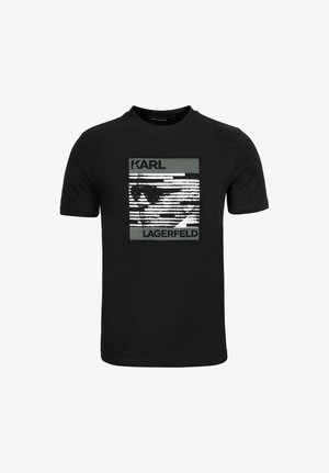 Black cotton t-shirt featuring a graphic print in white and gray. Design includes the text "KARL" and "LAGERFELD" with vertical lines.