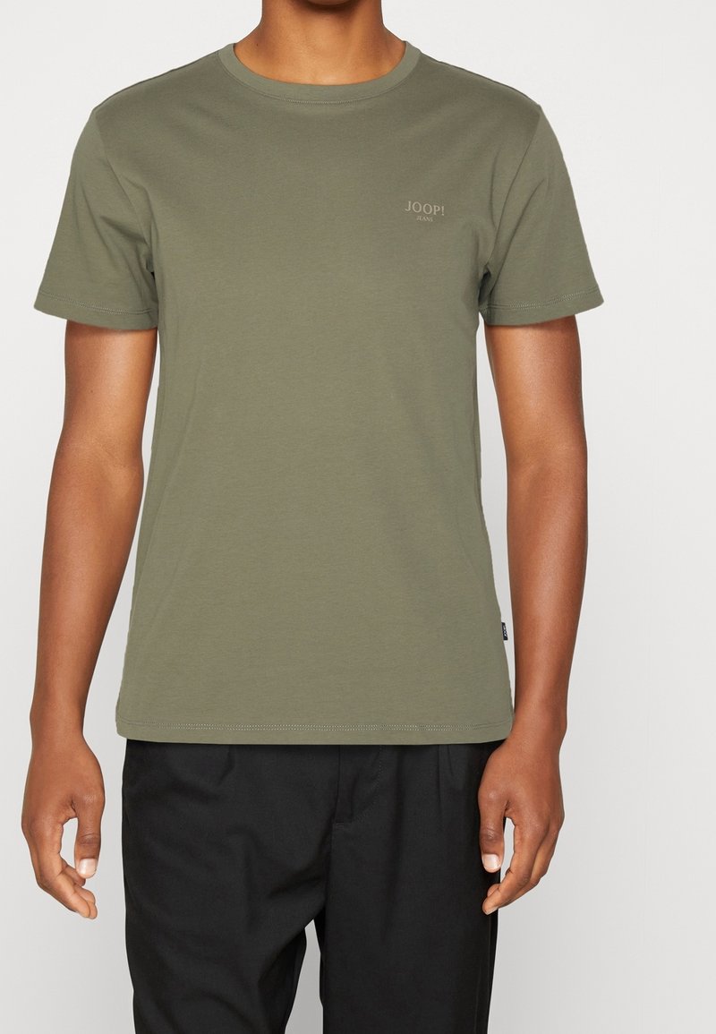 Olive green cotton t-shirt with a crew neck, short sleeves, and a small embroidered logo on the chest; smooth texture, casual fit.